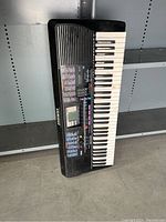 Full view of Yamaha electronic keyboard showing keys, control panel, and speaker grill.