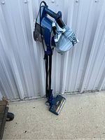 Full view of Zero M Rocket upright vacuum with handheld vacuum attached and cloth dust bag secured on handheld unit.