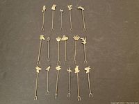 Full set of 17 Mexican silver pickle forks, each with unique decorative end.