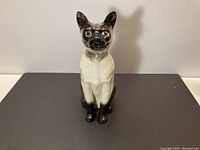 Front view of Beswick Siamese cat figurine showing detailed face and blue eyes.