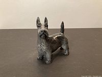 Front view of the Royal Copenhagen Scottish Terrier porcelain figurine depicting the dog standing with its ears up and tail raised.