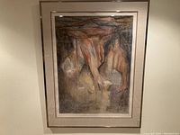 Full view of the framed abstract artwork with a crack visible in the glass, showing the entire piece hung on a wall.