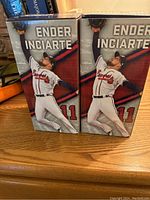 Two Ender Inciarte baseball bobbleheads in original boxes showing player in mid-action catch pose.