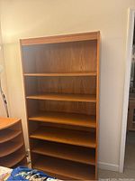 Front view of the wood laminate bookcase with five shelves.