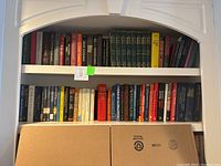 Bookshelves with various fiction and non-fiction books including bestsellers and literary classics.