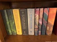 Photo showing nine Harry Potter hardback books by J.K. Rowling, all with dust jackets