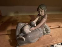 Lladró porcelain figurine of girl sitting with a cat on her lap, glossy pastel colors