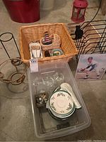 Set of various decorative and kitchen items including Spode saucers in a clear plastic container, wicker baskets, votive holders, wire file holder, antique model car, and decorative plates.