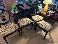 Set of six Thomasville dining chairs, four side chairs and two captain chairs with patterned upholstery, wood frames showing some wear.