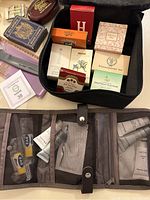 Black travel organizer opened displaying various boxed toiletries and soaps in assorted colors and packaging