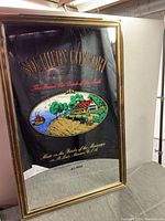 Framed Southern Comfort bar mirror with vintage advertisement, gold frame, 25 x 38 inches.