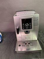 Front view of machine with drip tray and steam wand attached