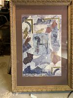 Pair of framed abstract paintings each centered with horse figure, surrounded by mixed media collage elements in muted blues, purples, and golds, within brown mats and gold ornate frames.