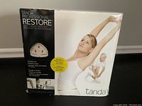 Box front showing product name, benefits like pain relief, improved motion, and treatment head longevity.