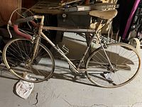 Silver CCM Silver Ghost road bike with rust and wear, red handlebar tape