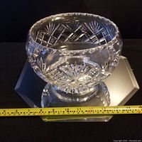 Front angle view of the antique crystal serving bowl with a measuring tape showing width near 8 inches, highlighting detailed cut patterns and thickness.