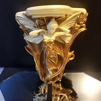Front and angled view of the very large Art Nouveau wall shelf sconce showing the fairy figure in gold and cream colors with wings and floral motifs.