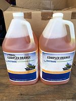 Two one-gallon jugs of Complex Orange Dustbane Degreaser placed side by side.