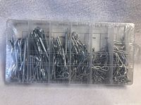 Top view of sealed plastic organizer box containing the cotter pins sorted by size into compartments.