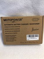 Closed box of Motopower Junior Automatic Battery Charger / Maintainer with product details and branding