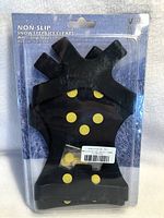 Photo of new black rubber snow and ice cleats with yellow anti-slip silicone studs in packaging, size XL 45-48.
