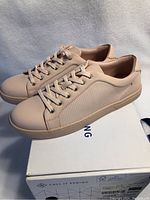 Side angle of pink Call It Spring women's sneakers on box