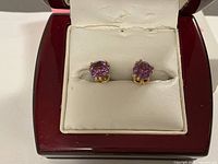 Pair of earrings displayed in cushioned jewelry box