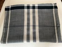 Folded scarf laid flat showing full plaid pattern and color scheme