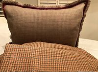 Decorative sham propped behind folded houndstooth sheet