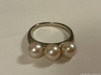 Top view of ring showing three pearls on white gold band