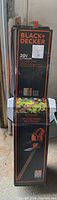 Box front shows Black+Decker branding with product details on 20V lithium hedge trimmer.