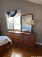 Front view of 9-drawer wood dresser with mirror