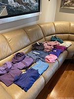 Wide shot of all tops laid out on couch