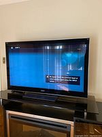Front view of TV turned on to blue input screen