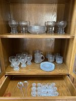 Overall view of textured glass set on shelves and in drawer