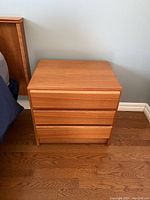 Front view of one table showing three drawers.