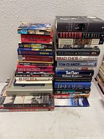 Stack of books showing spines and some covers, titles related to war and history.