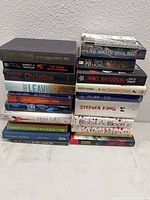 Photo showing stacked spines and covers of horror and suspense books in the lot, including Stephen King and James Patterson titles.