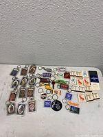 Overview of 87 Scottish Clan keychains and 17 matchbooks arranged on a white surface.