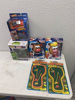 Photo showing all toys including Hot Wheels Cybertruck in box, Pop Marvel Hulk figure, Mr. Potato Head PlaySkool figures, and two mini golf playsets.