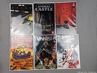 Six assorted comic books arranged in two rows of three, all in plastic protective sleeves.