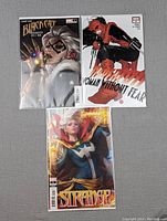 Photo of three comics: Black Cat, Daredevil, and Doctor Strange, each in a protective sleeve showing front covers with vibrant artwork.