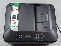 Top view of Canon PIXMA MX472 printer showing paper feeder and quality/promoted label.