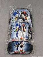 Backpack, lunch pail, and pencil case set all sealed in clear plastic packaging, showing Sonic and Shadow characters.