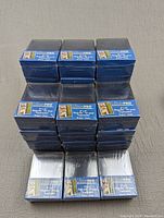 Stacked packages of Ultra Pro Toploader Series card sleeves, shrink wrapped in blue packaging.