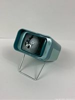 Front view showing projector lens and internal mirror.