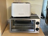 Photo showing white Toastmaster 2-slice toaster placed on top of the stainless steel Toastmaster toaster oven.