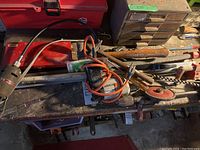 Overall view of lot items including power tools, clamps, hammer, saw, auger and flexible shaft tool