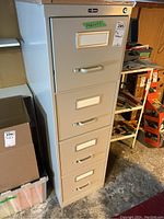 Front view of the four-drawer file cabinet showing ProSource logo, lock, and drawer handles.