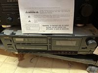 Front view of TEAC AD-3/AD-1 combo CD player and cassette deck. Shows control buttons, display, and volume knob.